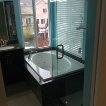 Bathroom remodeling with tub surround and glass shower enclosure